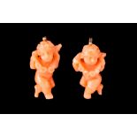 A PAIR OF CARVED CORAL EARRINGS, of cherub form, in case signed Jos Muller - Munchen.