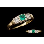 AN EMERALD AND DIAMOND THREE STONE RING in 18ct yellow and white gold,