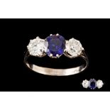 A SAPPHIRE AND DIAMOND THREE STONE RING, an oval cut sapphire of approx 1.