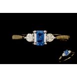 A SAPPHIRE AND DIAMOND THREE STONE RING, 18ct.