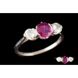 A RUBY AND DIAMOND THREE STONE RING, one round cut ruby of 0.77ct and diamonds of approx 0.