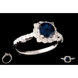 A SAPPHIRE AND DIAMOND CLUSTER RING, with one cushion cut sapphire of 1.56ct with gem report,
