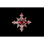 AN EARLY 19TH CENTURY CROSS SHAPE MOURNING BROOCH, with red foil backed gems,
