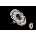 A SAPPHIRE AND DIAMOND OVAL SHIELD STYLE RING, with sapphires of approx. 1.