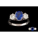 A SAPPHIRE AND DIAMOND THREE STONE RING, an oval cut sapphire of 2.