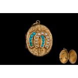AN ANTIQUE TURQUOISE AND SEED PEARL HORSESHOE GOLD LOCKET PENDANT