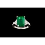 AN EMERALD AND DIAMOND RING, with IGI cert stating the emerald-cut Zambian emerald to be 5.22ct,