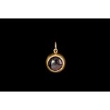 A GARNET FOB PENDANT IN 18CT GOLD, attributed to John Brogden