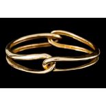 AN 18CT GOLD TWO PIECE INTERLOCKING BANGLE BY CARTIER