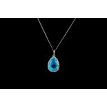 A BLUE TOPAZ PENDANT, surrounded by diamonds, mounted in white gold,