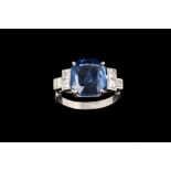 A SAPPHIRE AND DIAMOND RING, one octagonal cut sapphire of 6.41ct, with gem report, mounted in