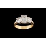 A DIAMOND THREE STONE RING, with HRD cert stating the central emerald cut diamond to be 1.