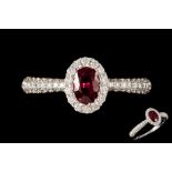 A RUBY AND DIAMOND OVAL CLUSTER RING, with ruby of approx. 0.55ct, diamonds of approx. 0.