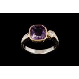 AN AMETHYST AND DIAMOND DRESS RING, with one cushion cut amethyst of 3.50ct and one round