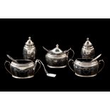 A GEORGE V SILVER FIVE PIECE CONDIMENT SET, with three spoons, chased bright cut decoration,