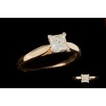 A DIAMOND PRINCESS CUT SOLITAIRE RING, the diamond is mounted in 18ct yellow gold.