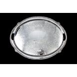 A LARGE HEAVY LATE VICTORIAN OVAL SILVER SERVING TRAY, with chaised and engraved decorations,