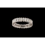 A DIAMOND ETERNITY RING, with baguette cut diamonds,