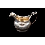 A SILVER GEORGIAN MILK JUG, by John Jonas,