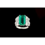 AN EMERALD AND DIAMOND RING, with one rectangular step cut emerald of 3.92ct, with gem report, and