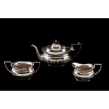 A MODERN IRISH SILVER THREE PIECE TEA SERVICE, with gadrooned decoration, Dublin 1962,