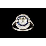 A SAPPHIRE AND DIAMOND TARGET CLUSTER RING, with centre old European cut diamond of approx. 1.