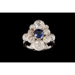 A SAPPHIRE AND DIAMOND FANCY CLUSTER RING, with one round cut sapphire of approx 1.