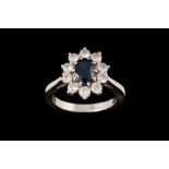 A SAPPHIRE AND DIAMOND OVAL CLUSTER RING, with sapphire of approx. 1.40ct, diamonds of approx. 1.