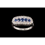 A SAPPHIRE AND DIAMOND DRESS RING, mounted in 18ct white gold and platinum,