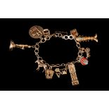 A 9CT GOLD CHARM BRACELET