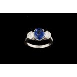 A SAPPHIRE AND DIAMOND THREE STONE RING, with one oval cut sapphire of 2.