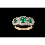 AN EMERALD AND DIAMOND TRIPLE CLUSTER RING