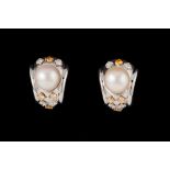 A PAIR OF CULTURED PEARL AND DIAMOND EAR-CLIPS, set with yellow and white diamonds of approx.1.