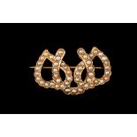 A LATE VICTORIAN HEART AND HORSESHOE BROOCH, set throughout with seed pearls.