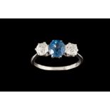 A SAPPHIRE AND DIAMOND THREE STONE RING, one oval sapphire of approx 1.