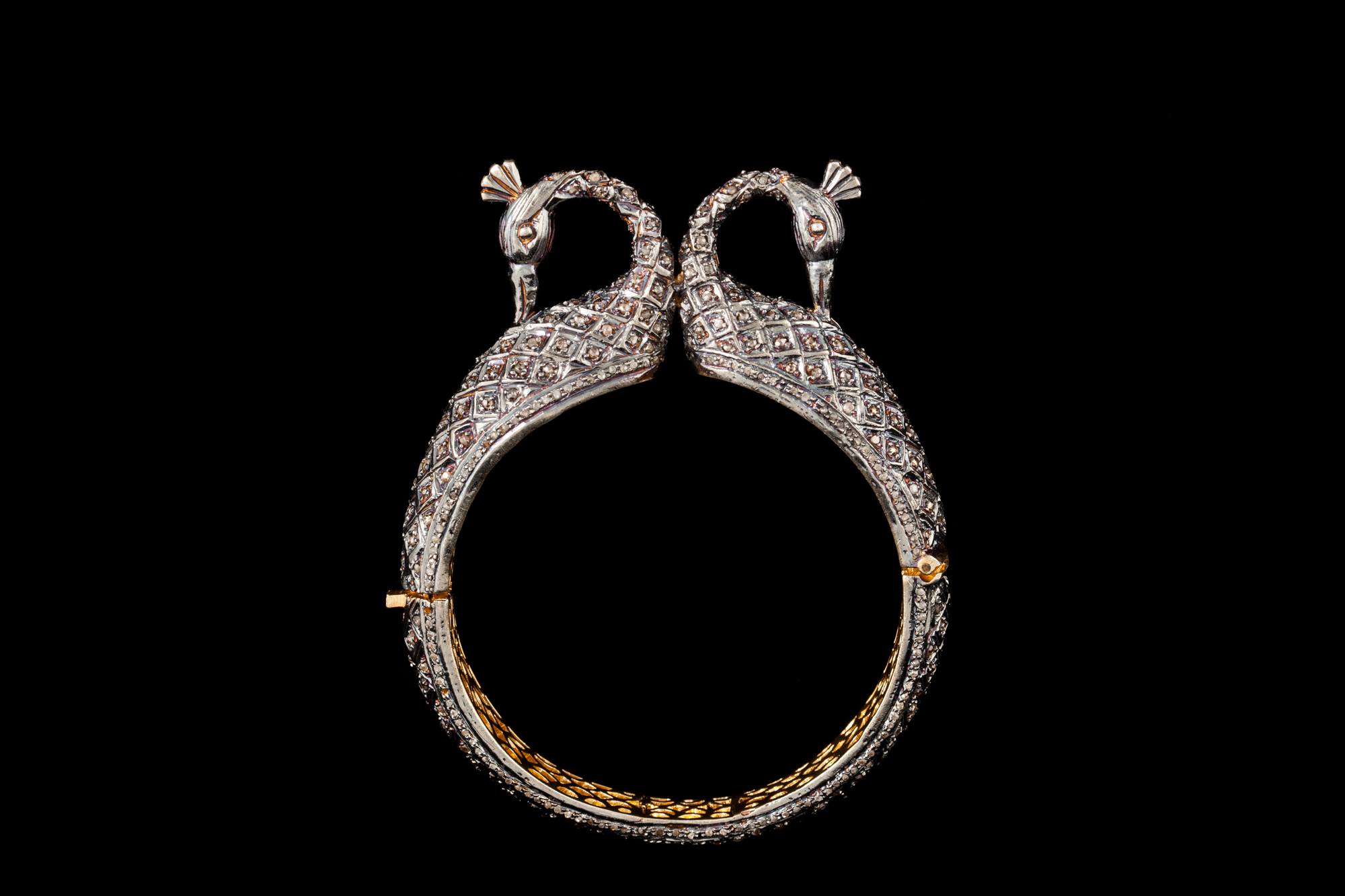 A DIAMOND SET BANGLE, in silver and gold,