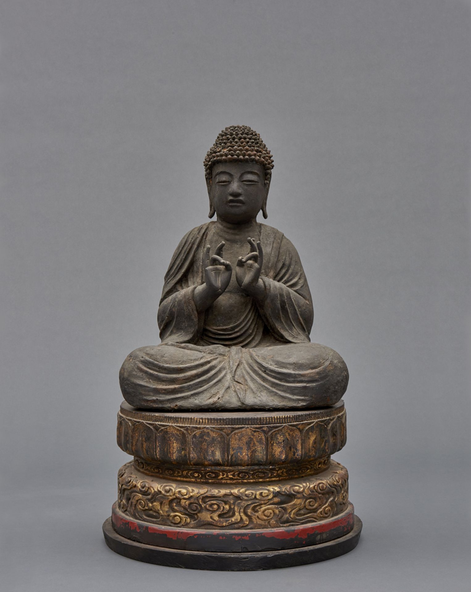 A large black lacquered massive wooden Buddha Amid