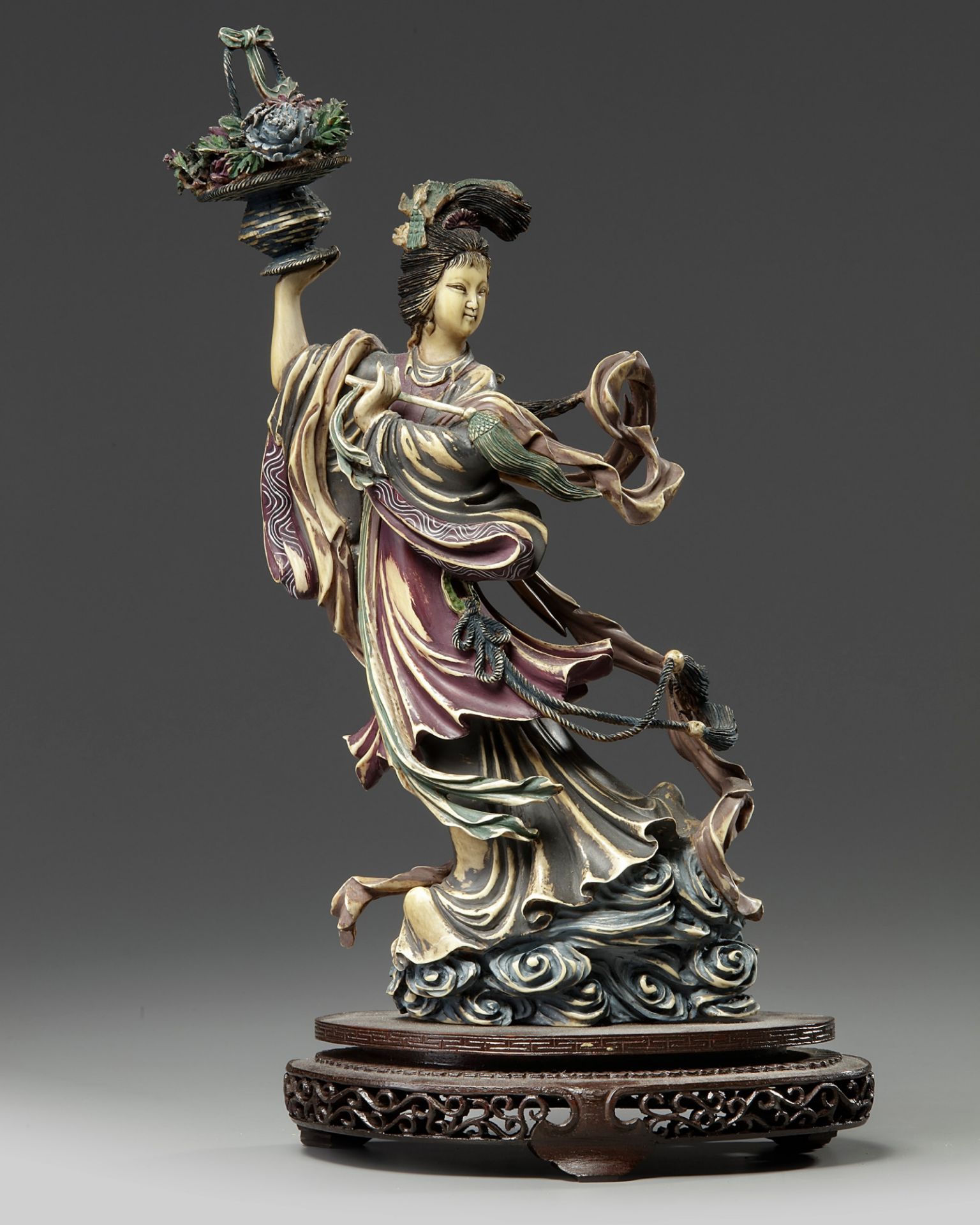 A Chinese polychrome-decorated ivory figure of a maiden