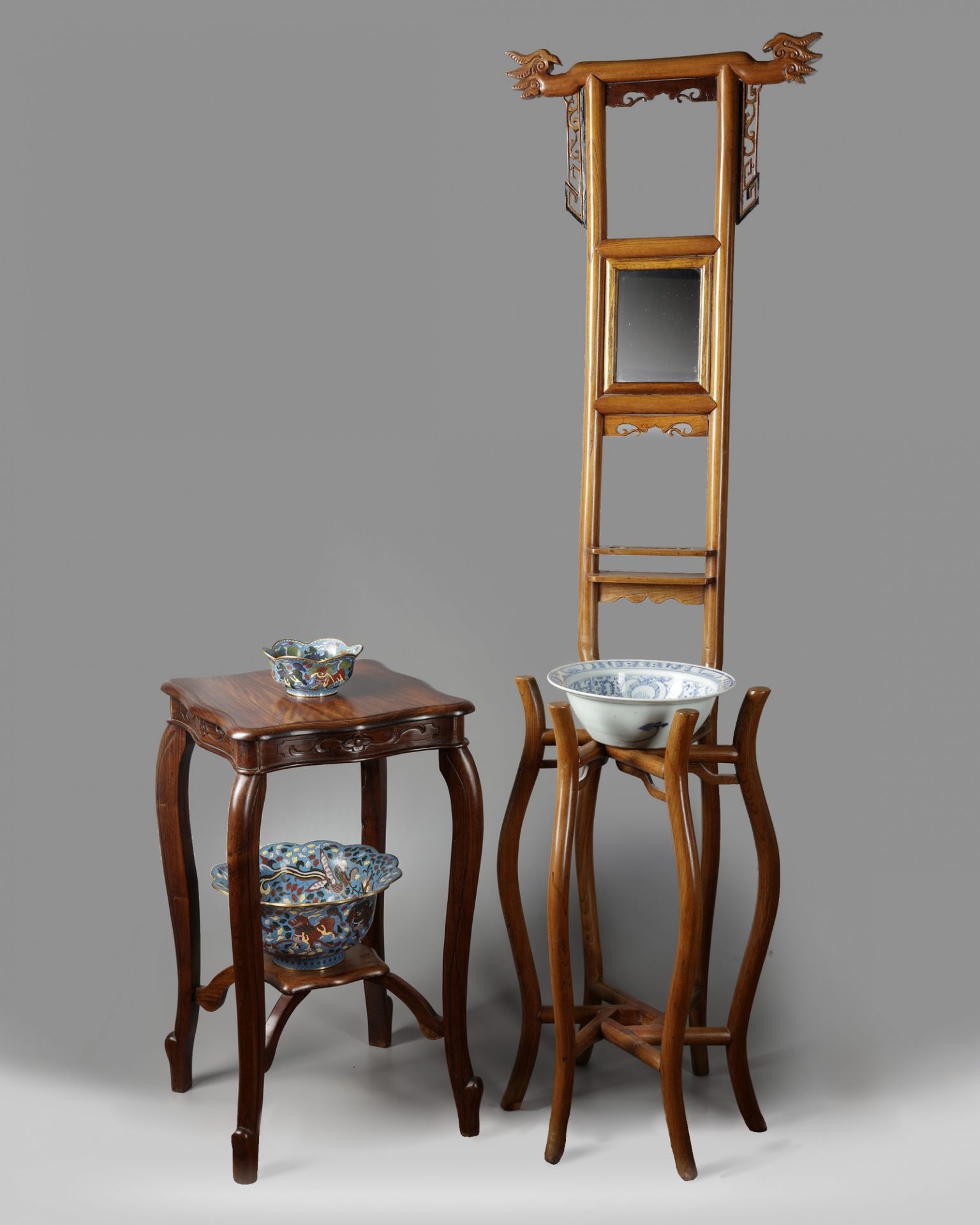 A Chinese hardwood mirror washstand with a basin and a hardwood stand
