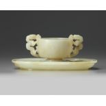 A Chinese white jade ‘twin chilong’ cup stand and a pale celadon jade cup