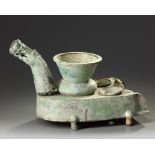 A Chinese green-glazed pottery stove with a dragon chimney