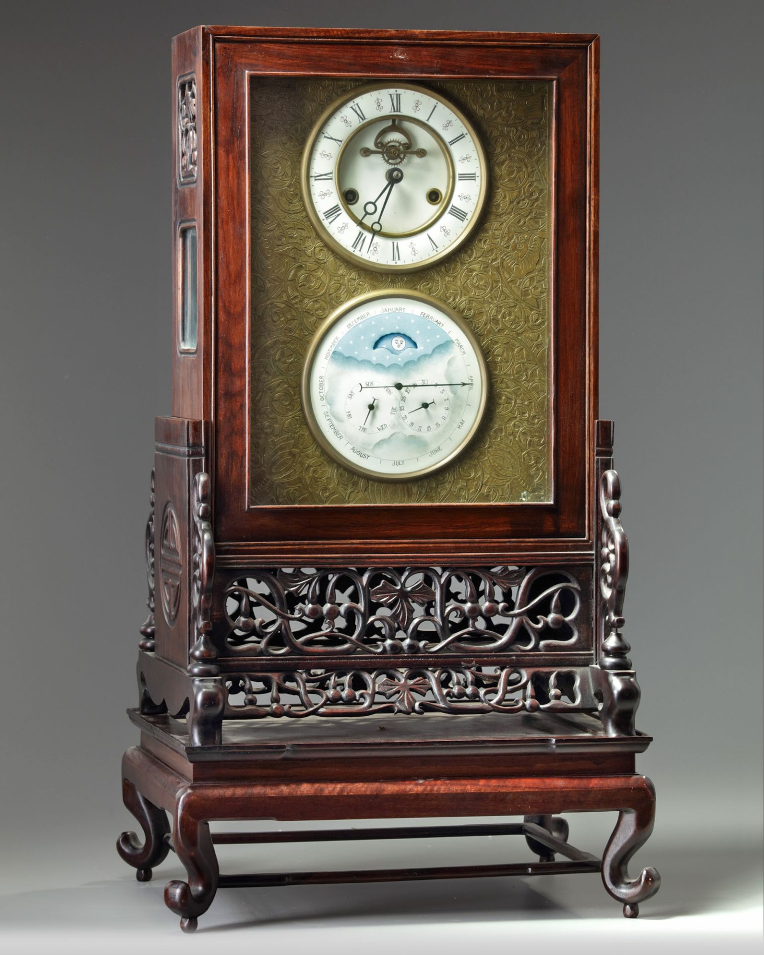 A Chinese gilt bronze clock in a hongmu case and stand