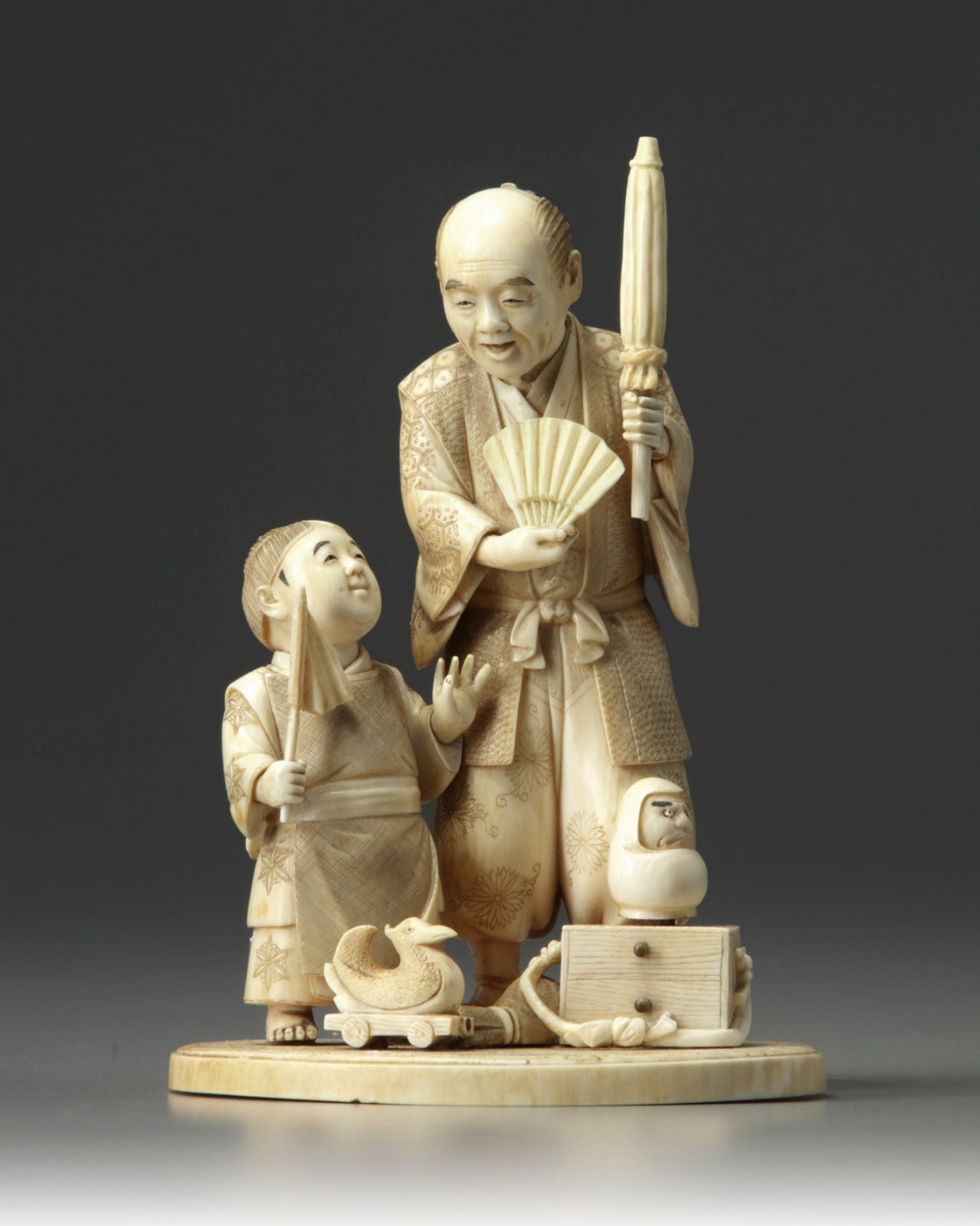 An ivory okimono of father and son