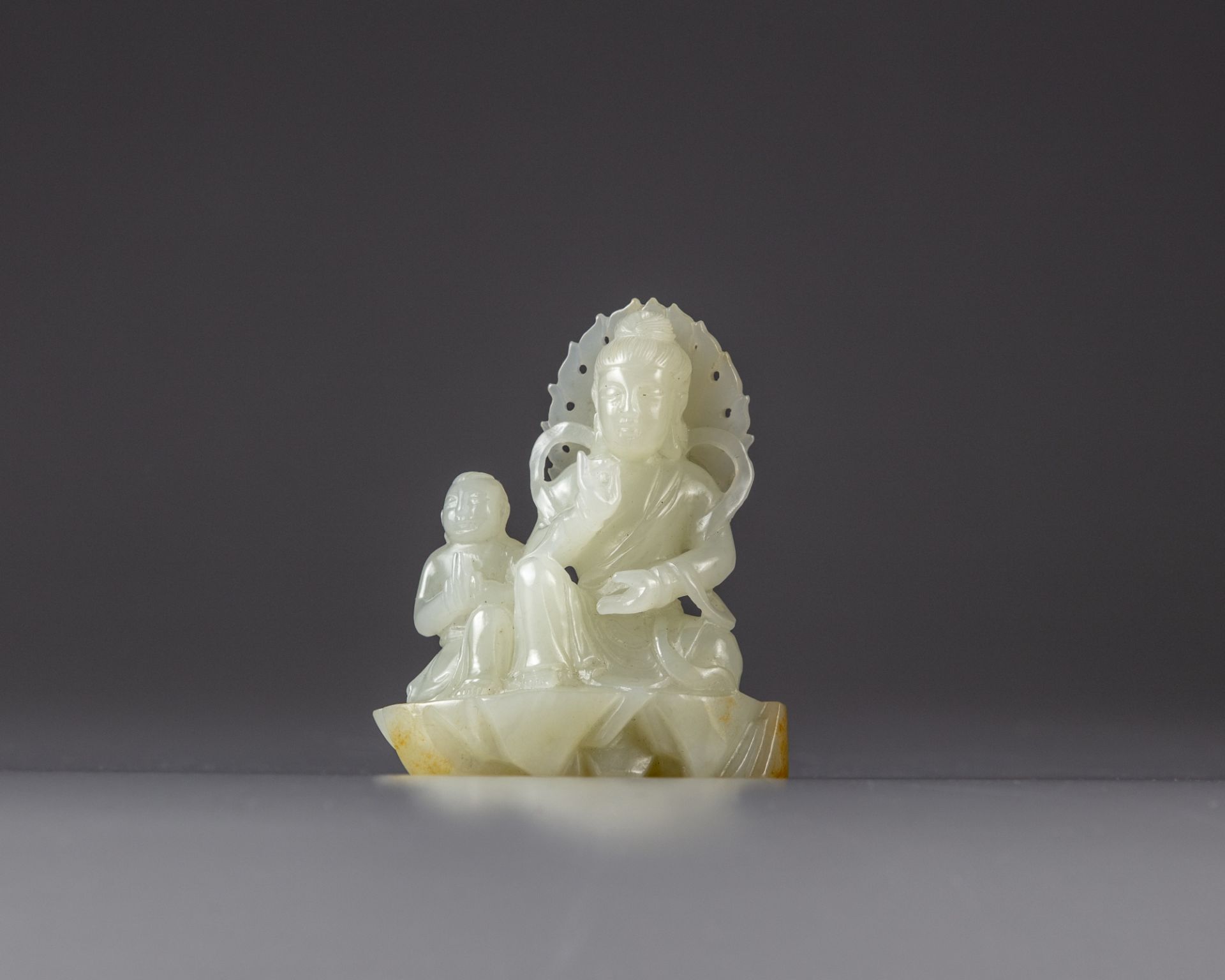 A Chinese white jade ‘Guanyin and acolyte’ carving
