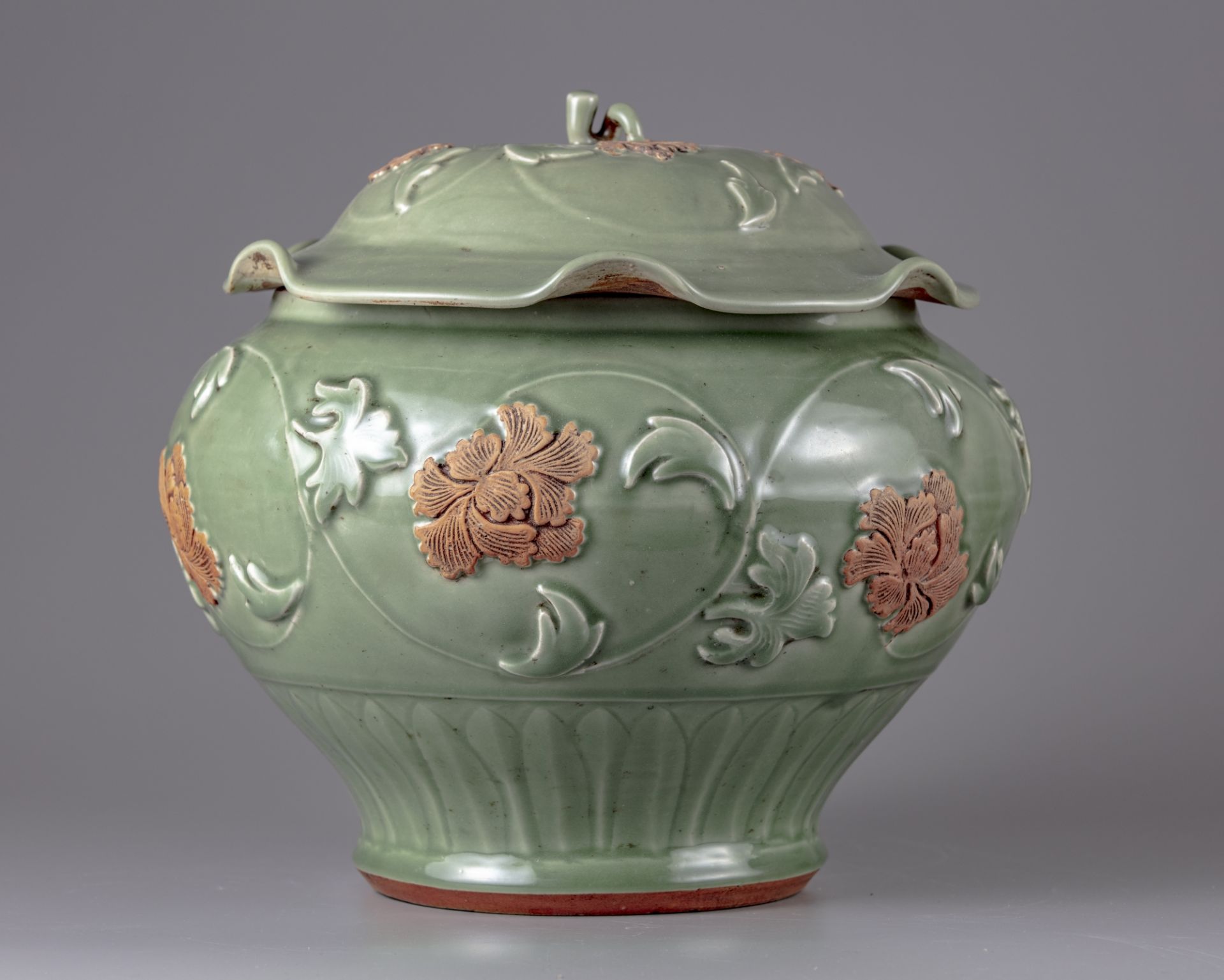 A celadon glazed jar and cover