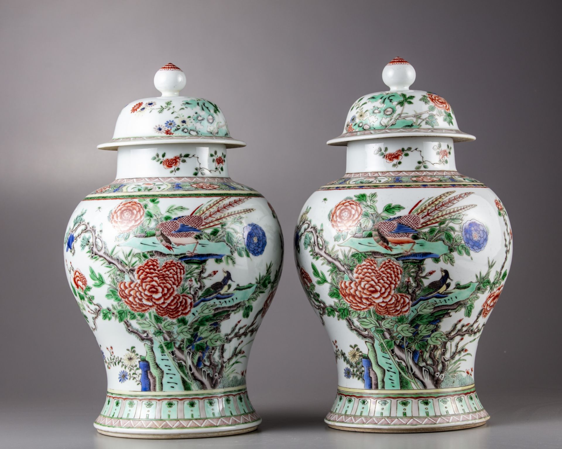 A pair of famille verte vases with cover