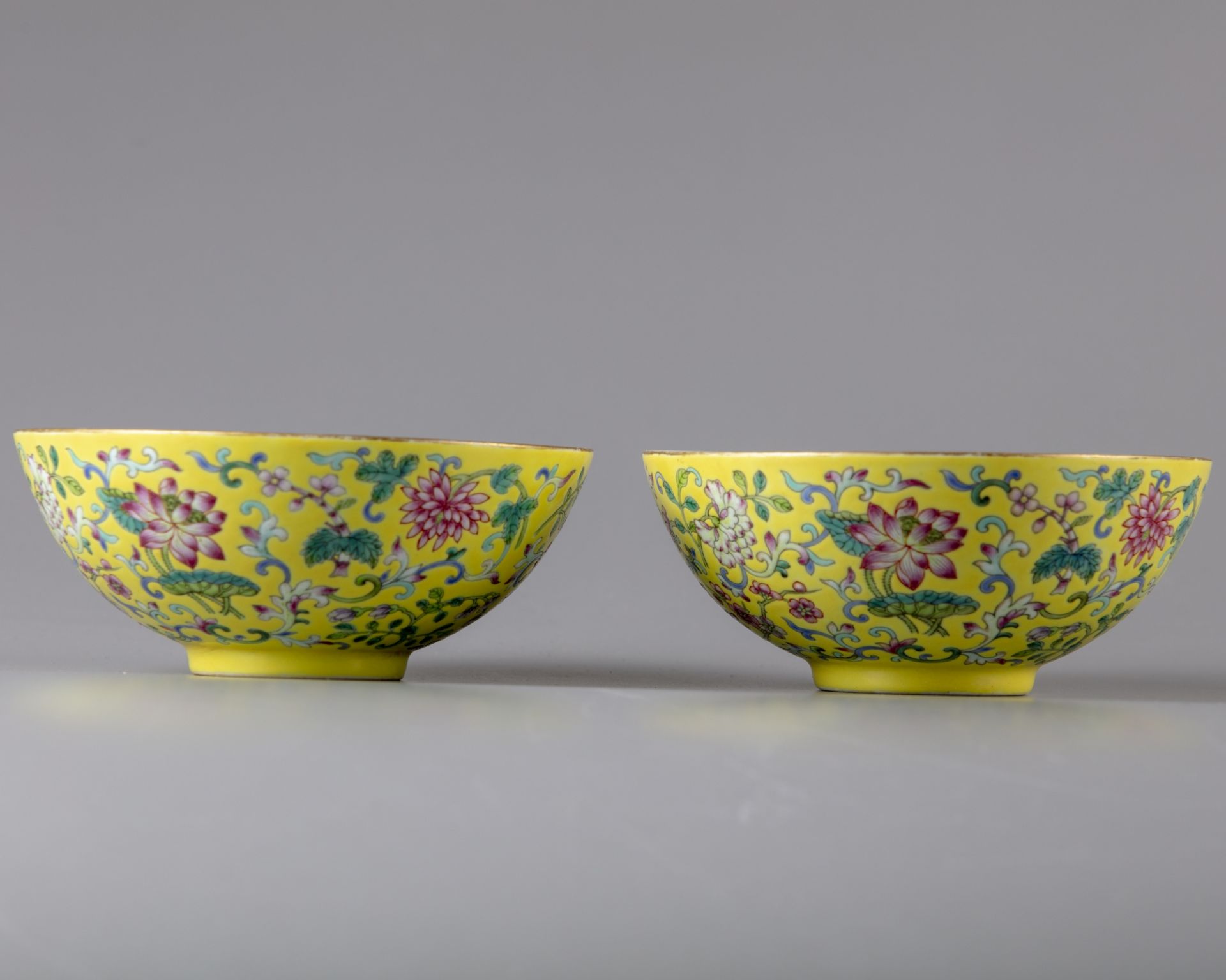 A pair of yellow-ground famille rose bowls