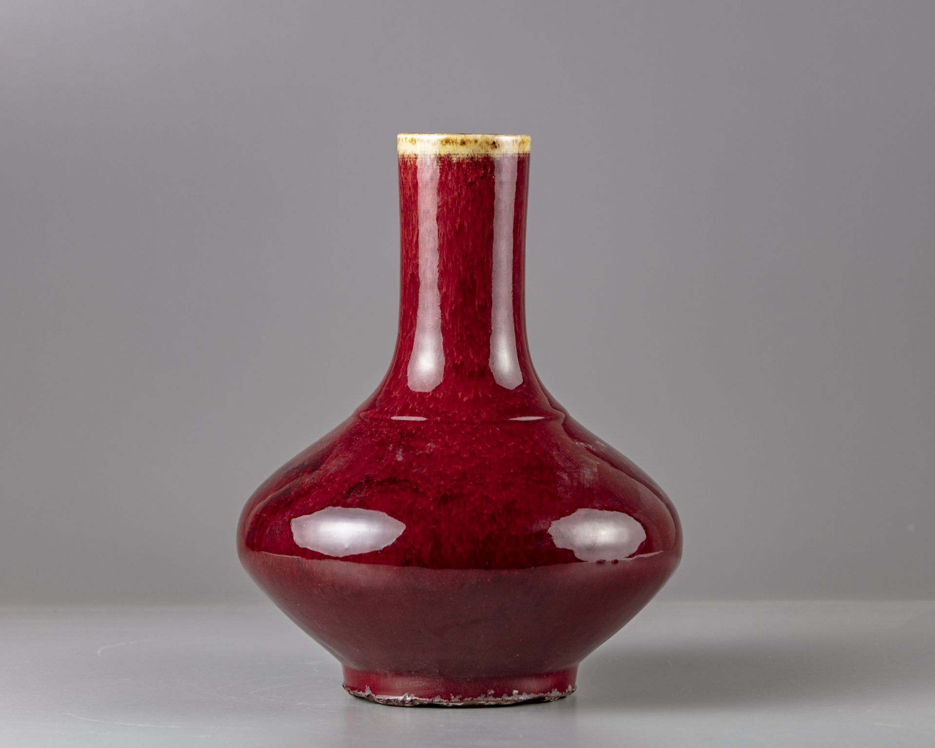 A red glazed bottle vase