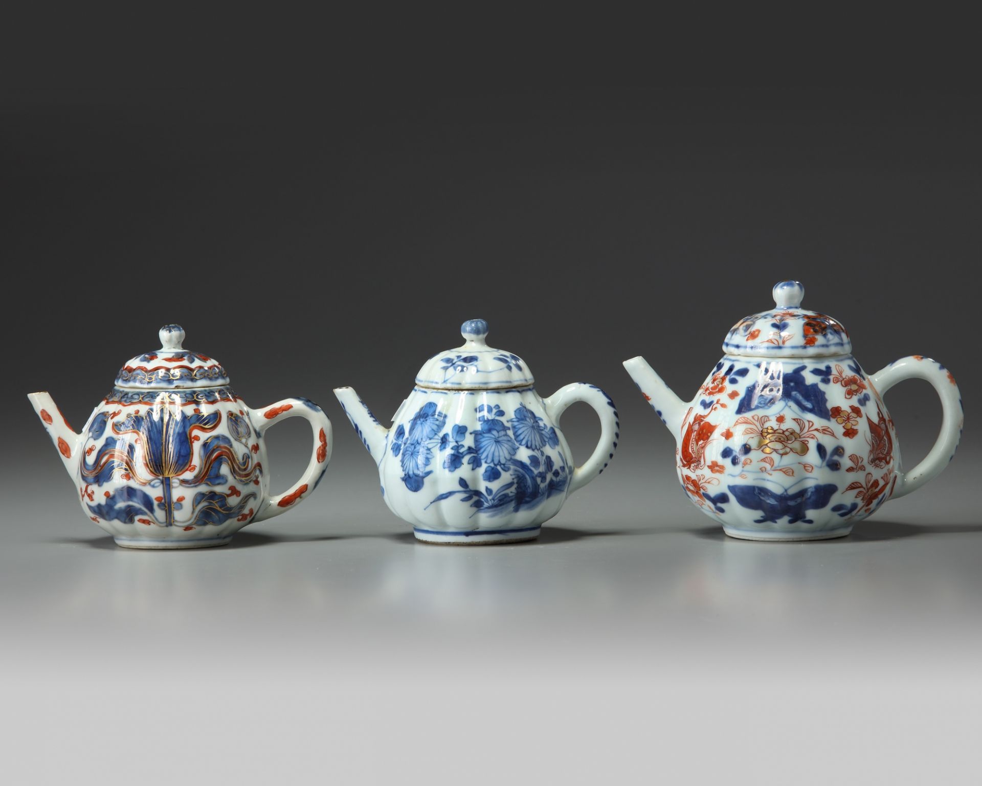 Three Chinese moulded teapots and covers