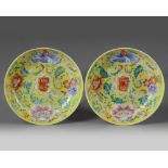 A pair of Chinese yellow-ground famille rose 'floral' dishes